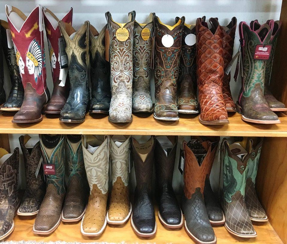 Cowboy boots displayed on shelves at Bullrider Western Wear
